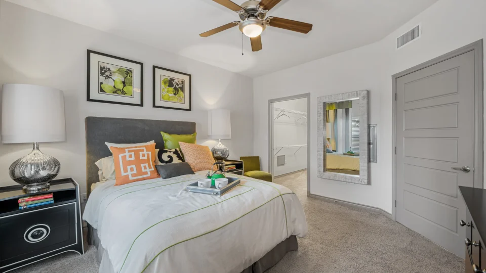 a bedroom with a bed, dresser, and ceiling fan at The  BLVD