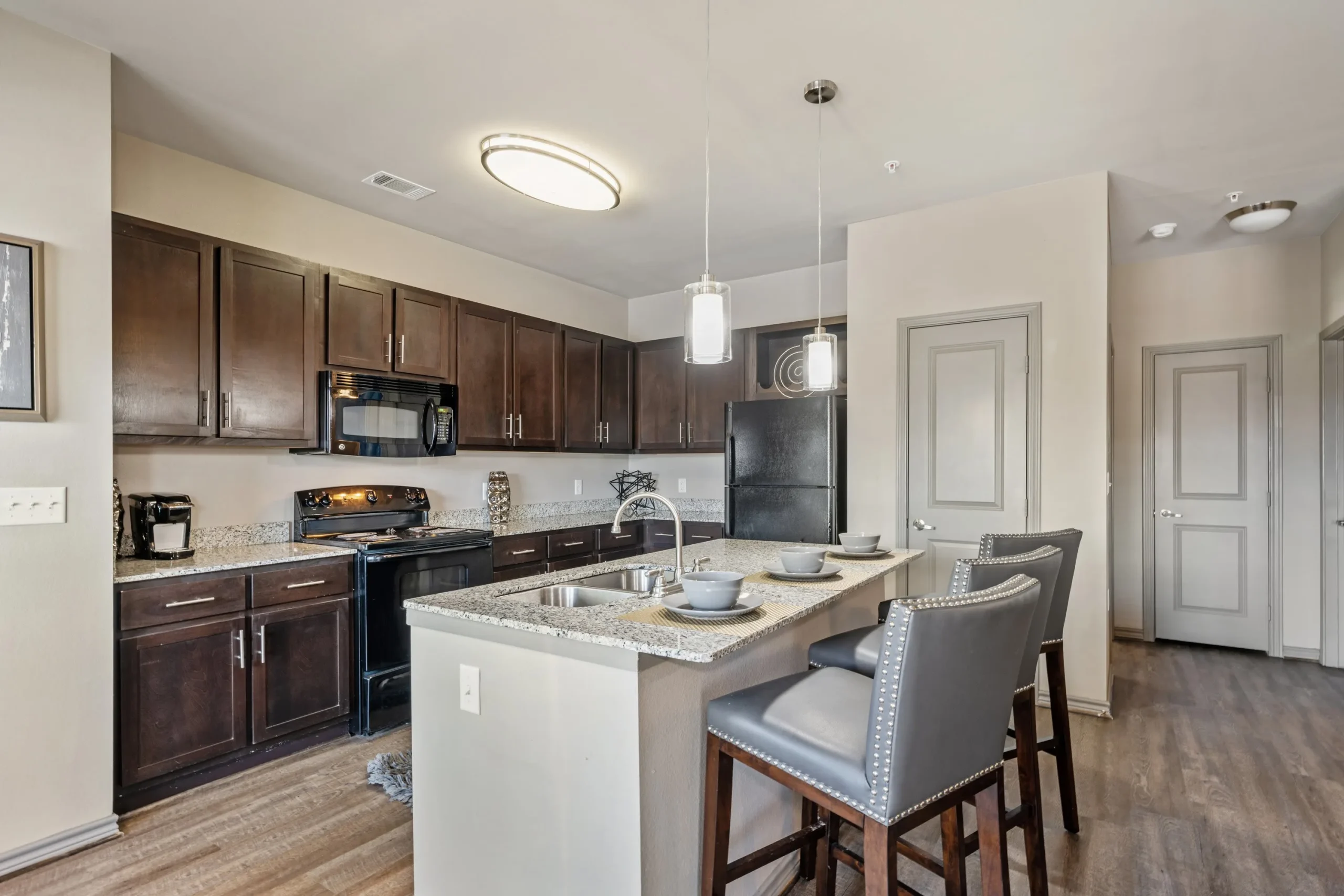 kitchen with stainless steel appliances and wood cabinets at The  BLVD