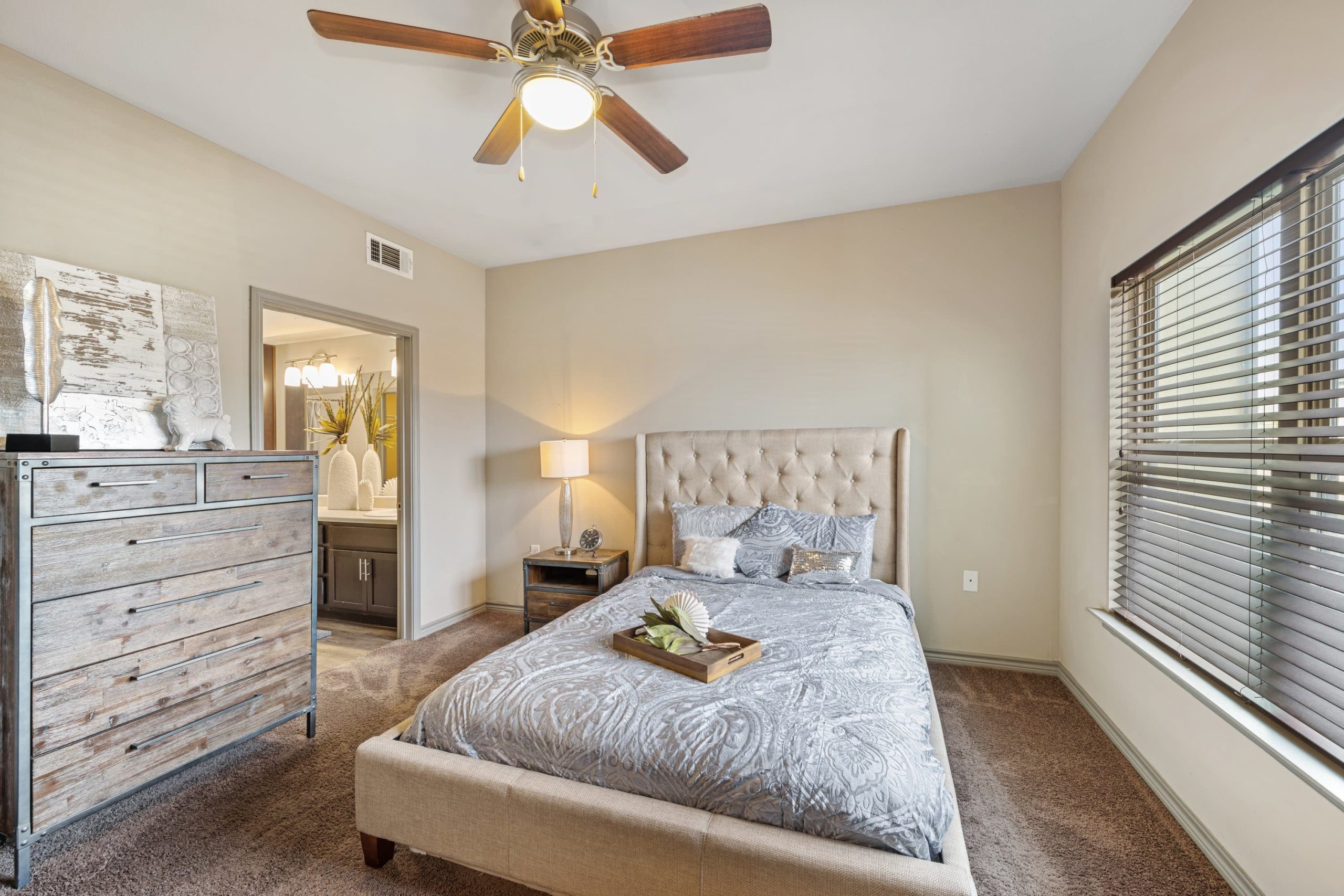 a bedroom with a ceiling fan and a bed at The  BLVD