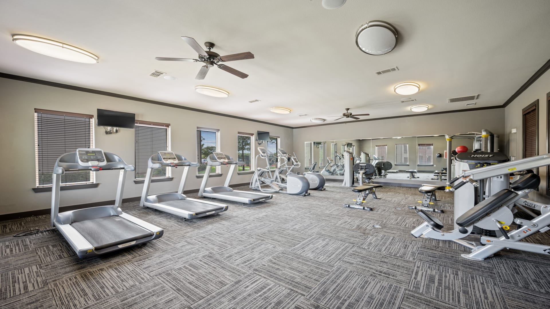 a gym room with treadmills and exercise equipment at The  BLVD