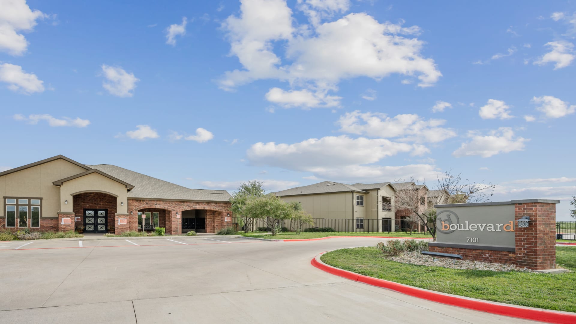 the entrance to a residential community with a parking lot at The  BLVD