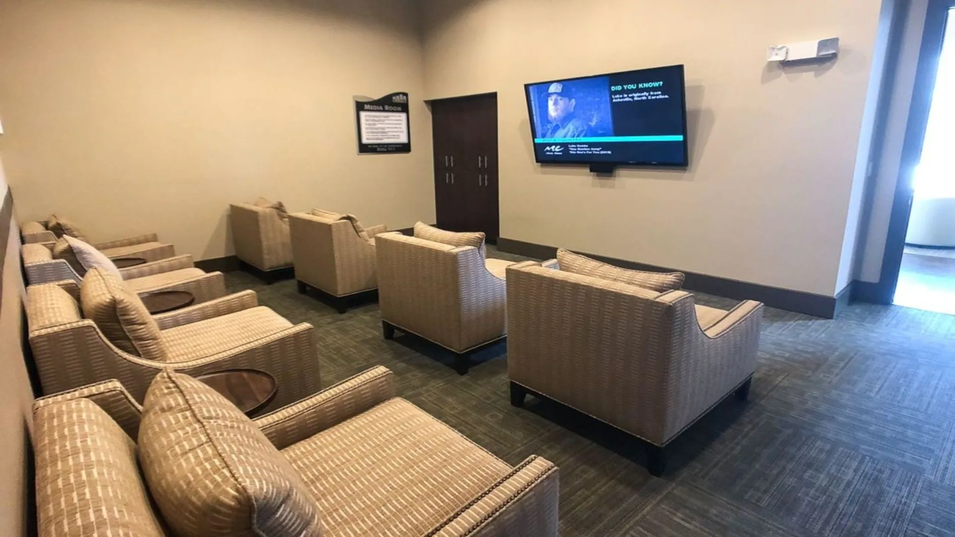 a waiting room with chairs and a flat screen tv at The  BLVD