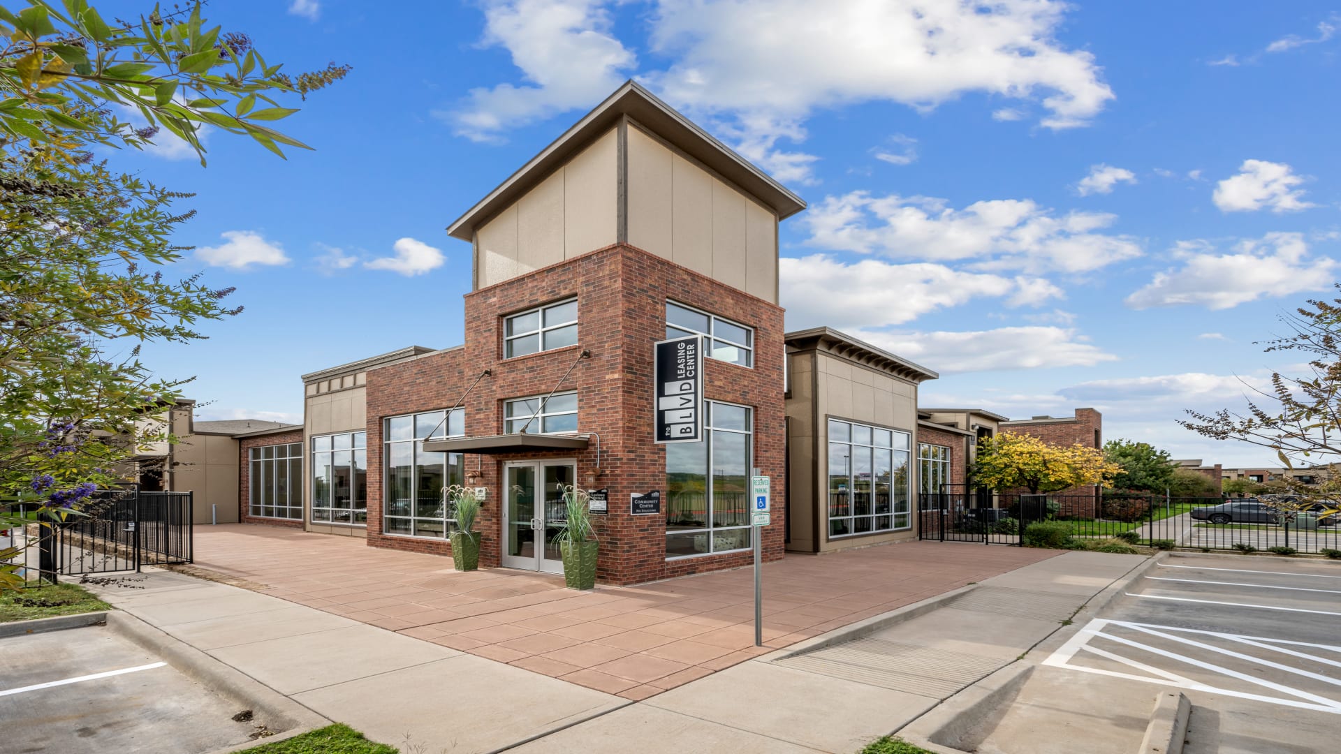 the front of a building with a parking lot and a sign at The  BLVD